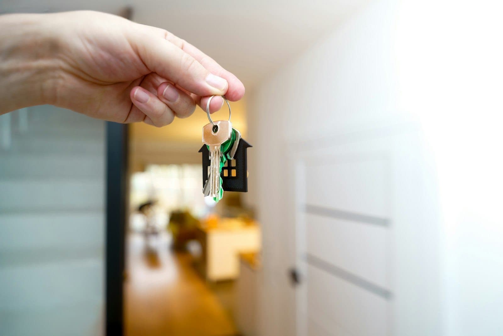 House keys being handed over inside a bright home